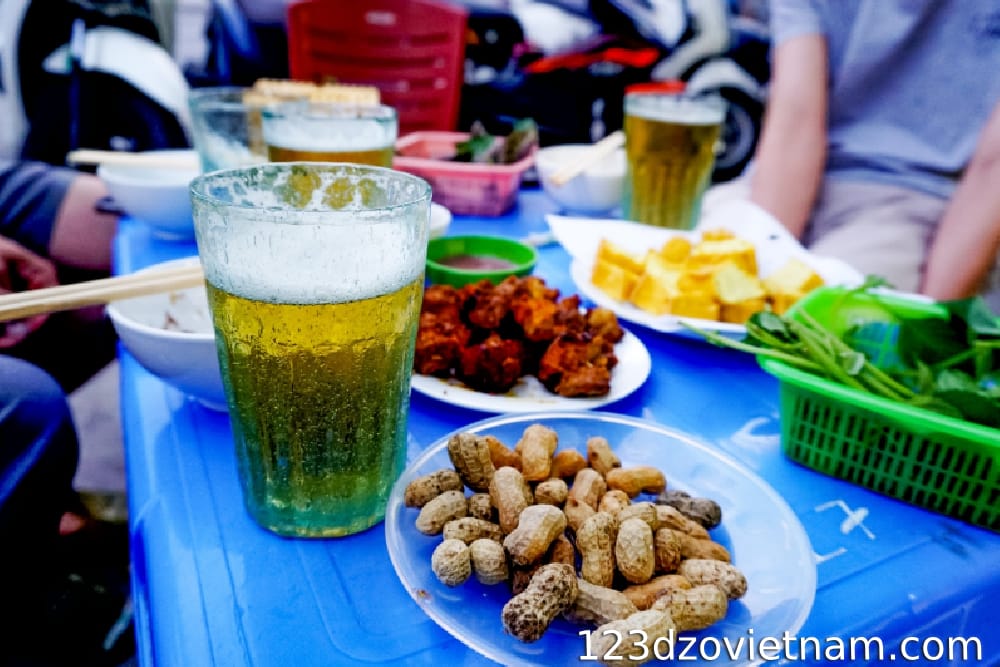 Drinking beer on the sidewalk in true Saigon style