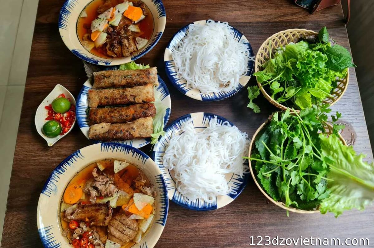 Eating Hanoi-style bun cha (grilled pork with vermicelli)