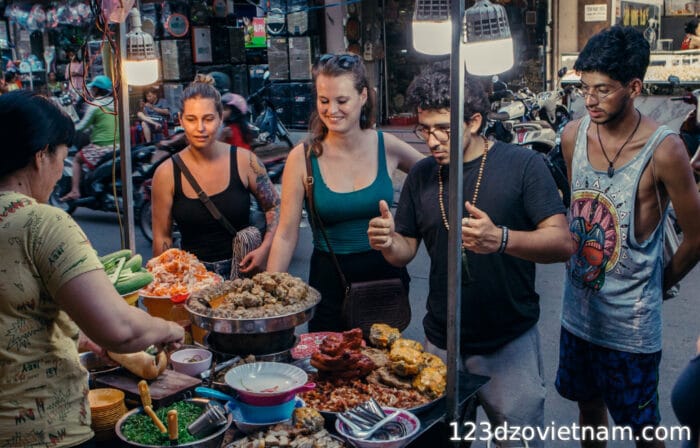 Travellers enjoying the street food of Vietnam